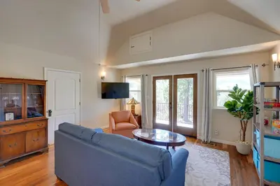 a living room with a blue couch and a table at Colfax Getaway with Hot Tub, Mountain Views! in Colfax