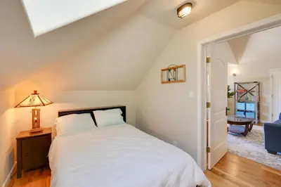 a bedroom with a bed and a lamp on a table at Colfax Getaway with Hot Tub, Mountain Views! in Colfax