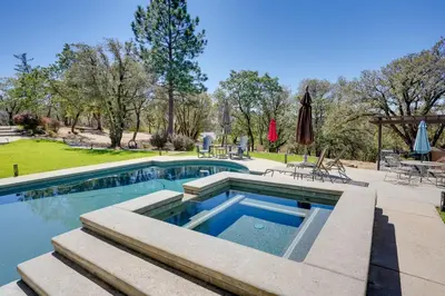 a swimming pool with a patio and a yard at Colfax Getaway with Hot Tub, Mountain Views! in Colfax