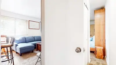 a living room with a blue couch and a table at La Vista Blanc #59 condo in Mammoth Lakes