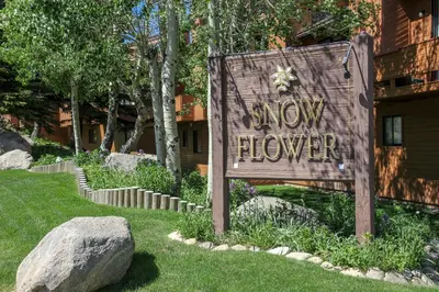 a sign that says slow flower in a yard at Snowflower #87 condo in Mammoth Lakes
