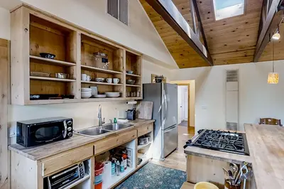 a kitchen with a sink and a refrigerator at Cascadel Hideaway in North Fork