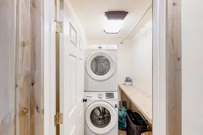 a small laundry room with a washer and dryer at Cascadel Hideaway in North Fork