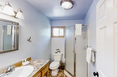 a bathroom with a toilet and a sink and a shower at Cascadel Hideaway in North Fork