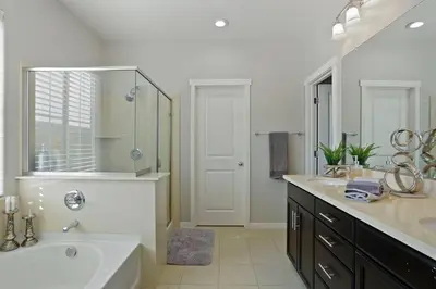 a bathroom with a tub and a sink and a mirror at Stunning River Islands Home Near Lake & Boat House in Lathrop
