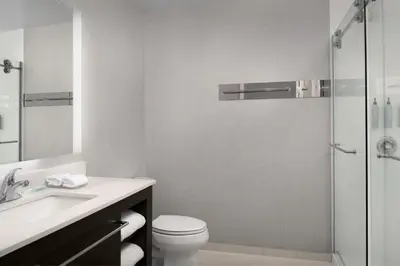 a bathroom with a toilet and a sink and a shower at Residence Inn by Marriott Fresno Clovis in Clovis