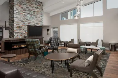 a waiting room with chairs and a flat screen tv at Residence Inn by Marriott Fresno Clovis in Clovis