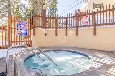 a hot tub in a pool with a fence at Perfect Ski Rental 2 blocks from Village Gondola in Mammoth Lakes