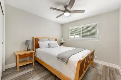 a bedroom with a bed and a ceiling fan at Fully Renovated 4 Bedroom Home with Pool! in Roseville