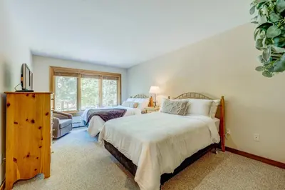 a bedroom with two beds and a window at Incline Escape in Incline Village