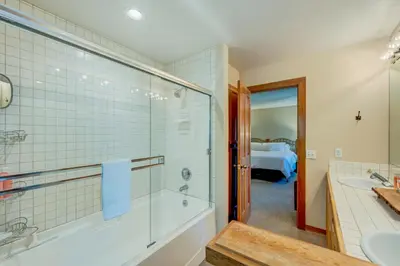 a bathroom with a shower and a tub and a sink at Incline Escape in Incline Village