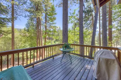 a wooden deck with a table and chairs on it at Incline Escape in Incline Village
