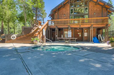 a home with a pool in front of a house at Incline Escape in Incline Village