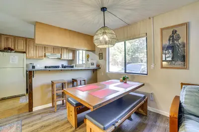 a kitchen with a wooden table and a dining room at Cozy Mammoth Lakes Studio 5 Mi to Ski Slopes in Mammoth Lakes