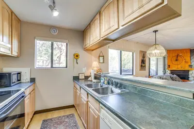 a large kitchen with wooden cabinets and a sink at Cozy Mammoth Lakes Studio 5 Mi to Ski Slopes in Mammoth Lakes