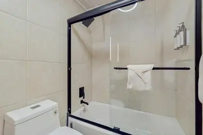a bathroom with a toilet and a glass shower door at Sierra Nevada Serenity in South Lake Tahoe