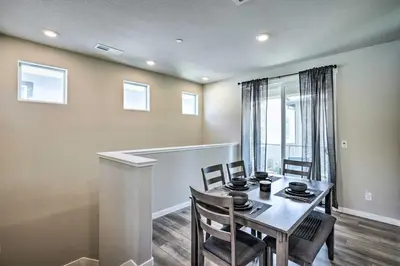 a dining room with a table and chairs and a window at Pet-Friendly Elk Grove Retreat with Balcony! in Elk Grove