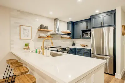 a kitchen with a large white counter top and blue cabinets at Incline Village Stunner in Incline Village