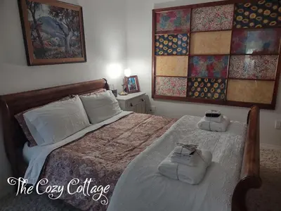 a bedroom with a bed with two towels on it at Cozy Cottage in Miramonte