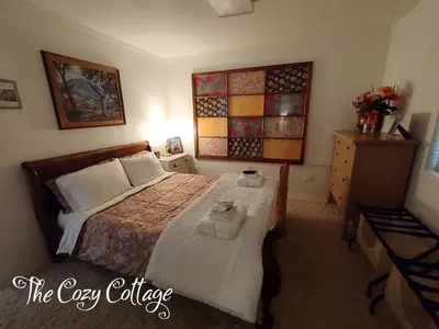 a bedroom with a bed and a dresser at Cozy Cottage in Miramonte