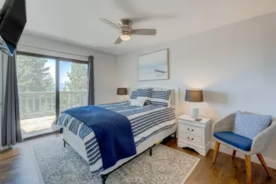 a bedroom with a bed and a chair and a window at Casa Azul in Incline Village