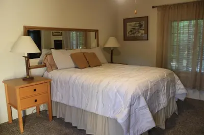 a bedroom with a bed and a table with a night stand at The Bonnie Inn Unit 5 with Breakfast Nook in San Andreas