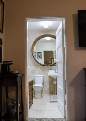 a bathroom with a toilet and a mirror at The Bonnie Inn Unit 5 with Breakfast Nook in San Andreas