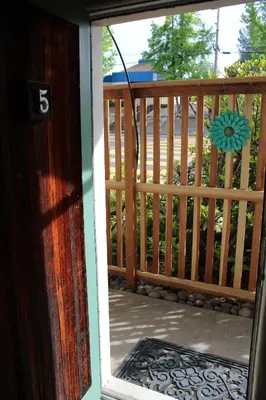 an open door to a porch with a wooden fence at The Bonnie Inn Unit 5 with Breakfast Nook in San Andreas