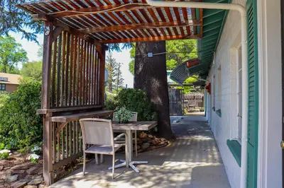 a table and chairs sitting under a wooden pergola at The Bonnie Inn Unit 6 in San Andreas