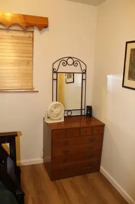 a dresser with a mirror on top of it at Rustic Chapparal Cabin at Bass Lake Heights in Oakhurst