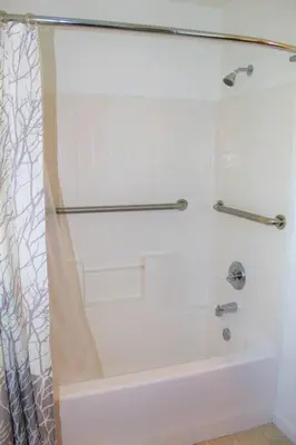 a bathroom with a shower and a white tub at Rustic Chapparal Cabin at Bass Lake Heights in Oakhurst