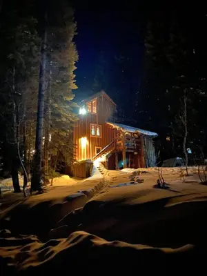 a log cabin in the snow at night at Amazing Architecture - Views all around VH#113 in Tamarack
