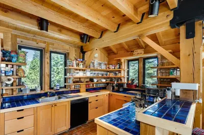 a large kitchen with wooden cabinets and blue counter tops at Amazing Architecture - Views all around VH#113 in Tamarack