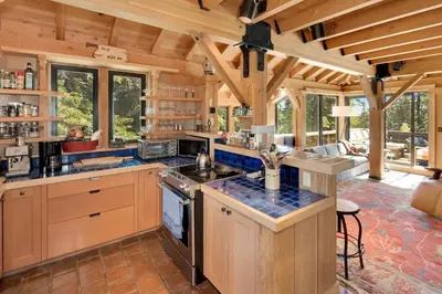 a large kitchen with wooden cabinets and a large room at Amazing Architecture - Views all around VH#113 in Tamarack