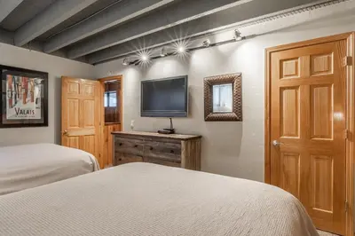 a bedroom with two beds and a flat screen tv at Updated 5 Bedroom 3 bathroom townhome Slopeside at 1849 Condos 671 sleeps 10 in Mammoth Lakes