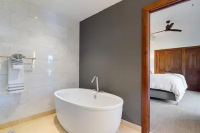a white bath tub in a bathroom with a bedroom at Ultimate Luxury Residence with Extras Galore across from Heavenly Village & Gondola - Zalanta Resort in South Lake Tahoe