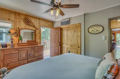 a bedroom with a bed and a dresser and a mirror at Rustic Oakhurst Retreat Less Than 4 Mi to Bass Lake! in Oakhurst