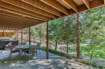 a patio with a table and chairs and a tree at Rustic Oakhurst Retreat Less Than 4 Mi to Bass Lake! in Oakhurst