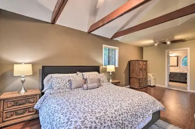 a bedroom with a large bed with pillows at Deck and Grill Mtn Haven in Stanislaus Natl Forest in Arnold
