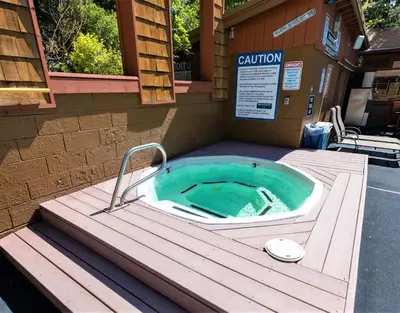 a jacuzzi tub on a wooden deck in a building at Cedar Glen Lodge in Tahoe Vista