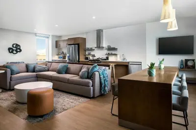 a living room with a couch and a kitchen at Element Reno Experience District in Reno