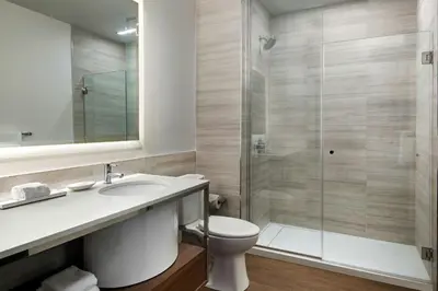 a bathroom with a toilet and a glass shower at Element Reno Experience District in Reno