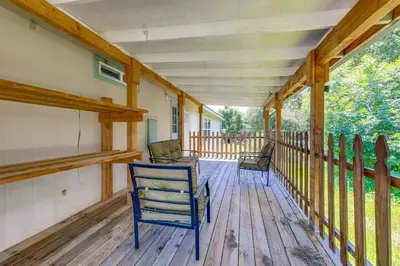 a porch with two chairs on a wooden deck at 33 Mi to Yosemite Secluded Mariposa Retreat! in Mariposa