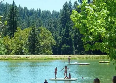 a group of people standing on surfboards in the water at Lakeside BLS Retreat near Big Trees & Bear Valley in Arnold