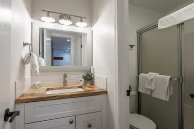 a bathroom with a sink and a mirror and a toilet at Highly updated 1 Bedroom plus den, 2 bath Crestview Unit 5 Sleeps up to 4 located near Canyon Lodge in Mammoth Lakes