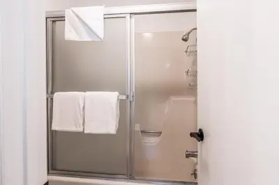 a bathroom with a shower with white towels at Highly updated 1 Bedroom plus den, 2 bath Crestview Unit 5 Sleeps up to 4 located near Canyon Lodge in Mammoth Lakes