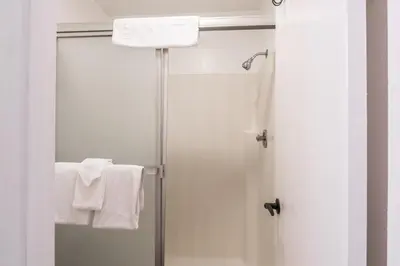 a bathroom with a shower with white towels at Highly updated 1 Bedroom plus den, 2 bath Crestview Unit 5 Sleeps up to 4 located near Canyon Lodge in Mammoth Lakes