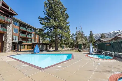 a swimming pool in the courtyard of a resort at Ski in Ski Out Juniper Springs Lodge #351 Luxury Slope-side 2 Bedrm 2 Bath End Unit! in Mammoth Lakes