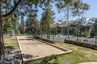 a sidewalk in front of a house with a fence at Ski in Ski Out Juniper Springs Lodge #351 Luxury Slope-side 2 Bedrm 2 Bath End Unit! in Mammoth Lakes