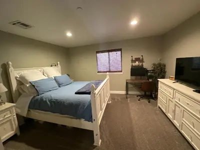 a bedroom with a bed and a flat screen tv at Historic Washington St Balcony in Sonora